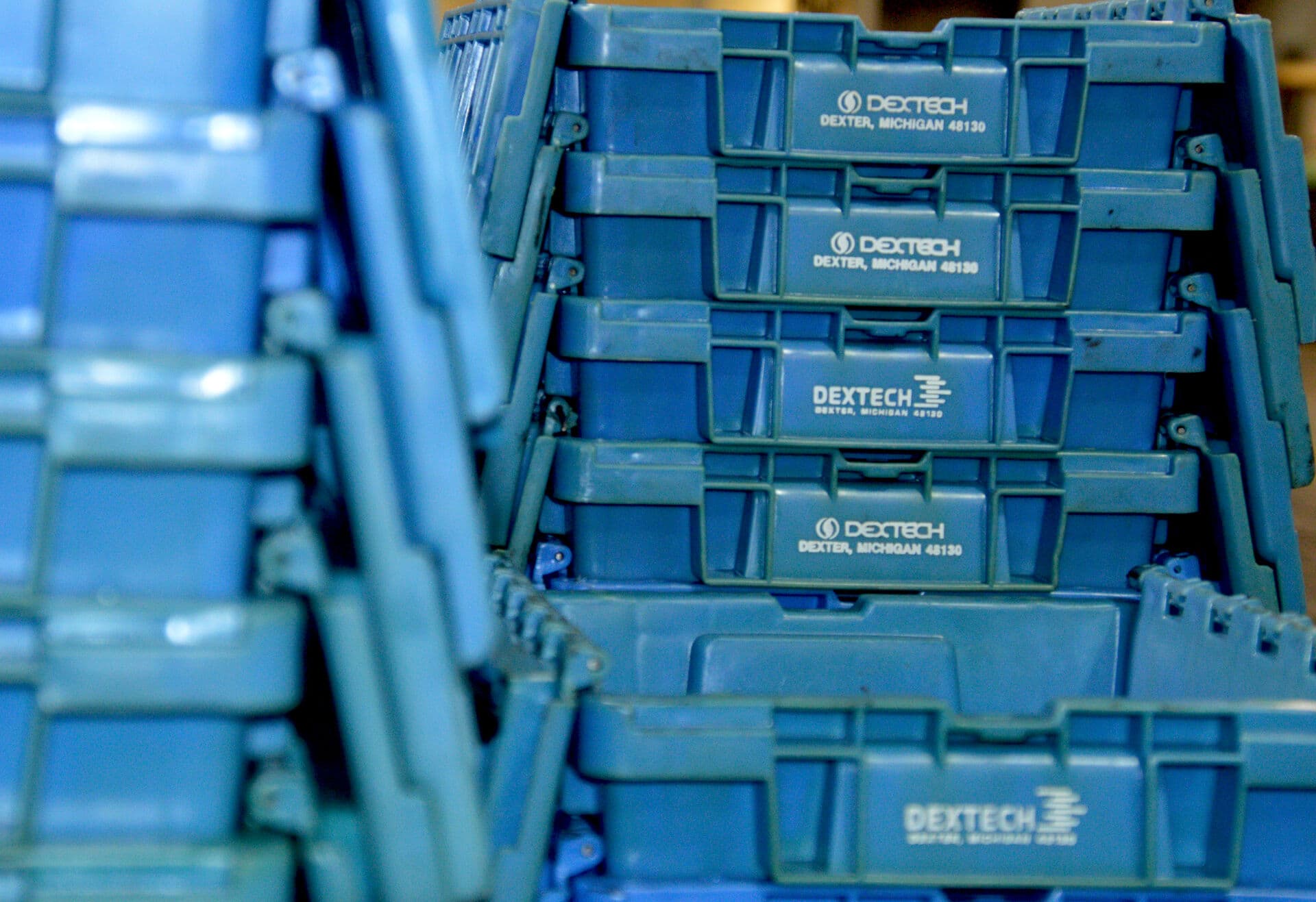 Stacks of blue plastic dunnage containers