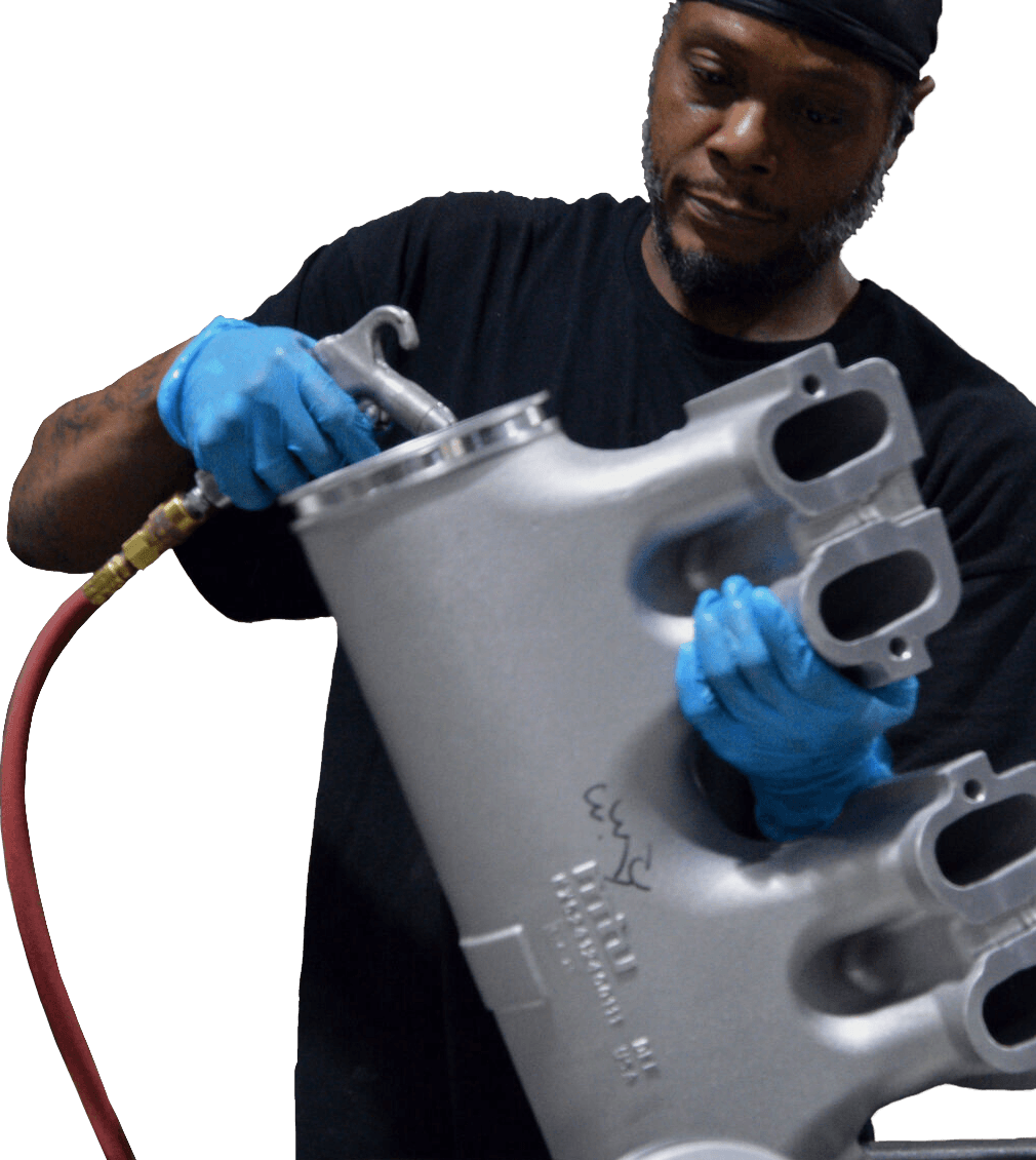 Technician performing precision cleaning on a metal part